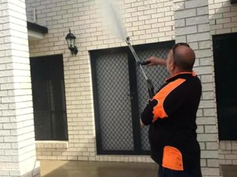 Soft washing a brick home exterior