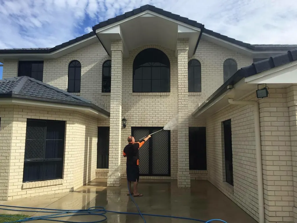 Two storey house exterior being soft washed