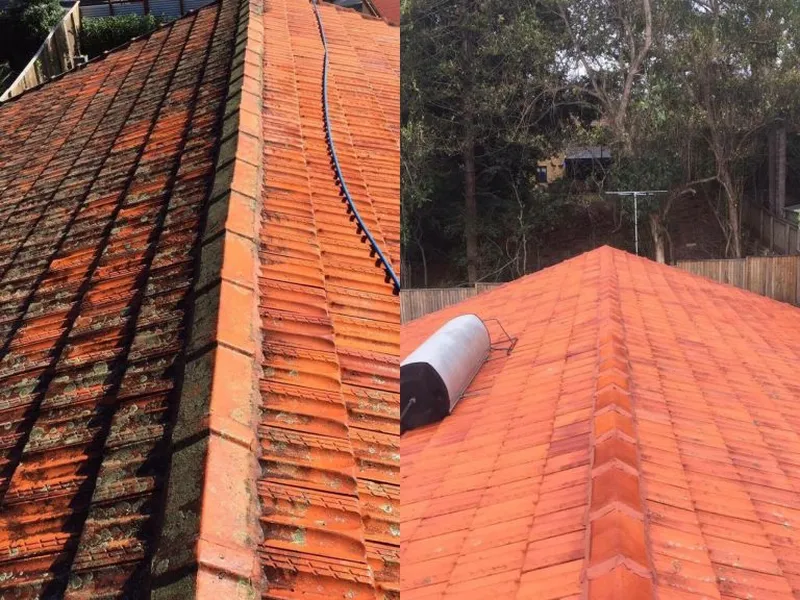 Roof cleaning in progress on a tiled roof